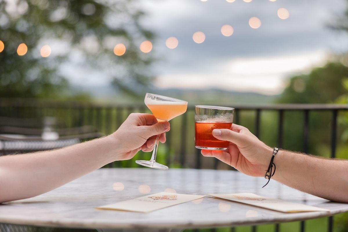 Two people toast with some of Sean’s cool cocktails out on the deck